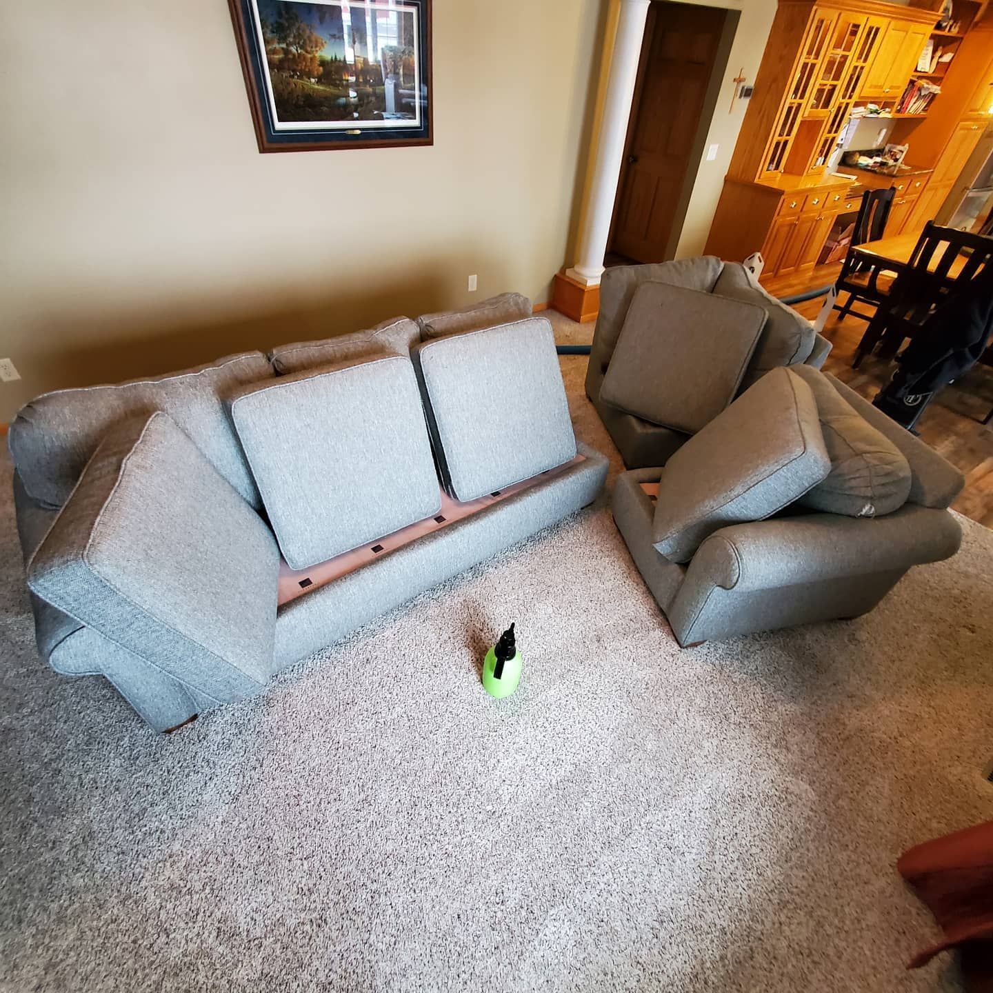 A living room with a couch and chair sitting on the floor