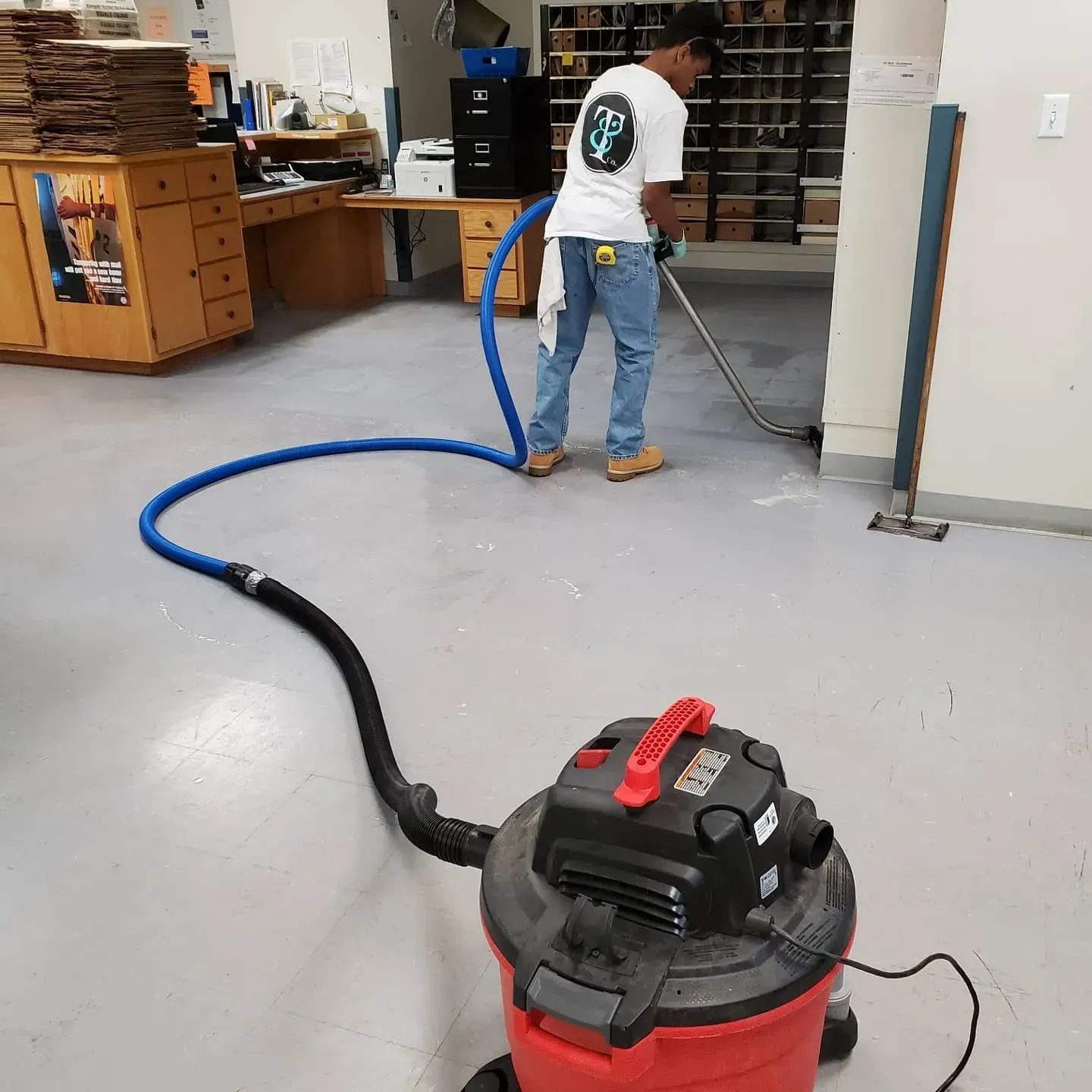 A man is using a vacuum cleaner in a room