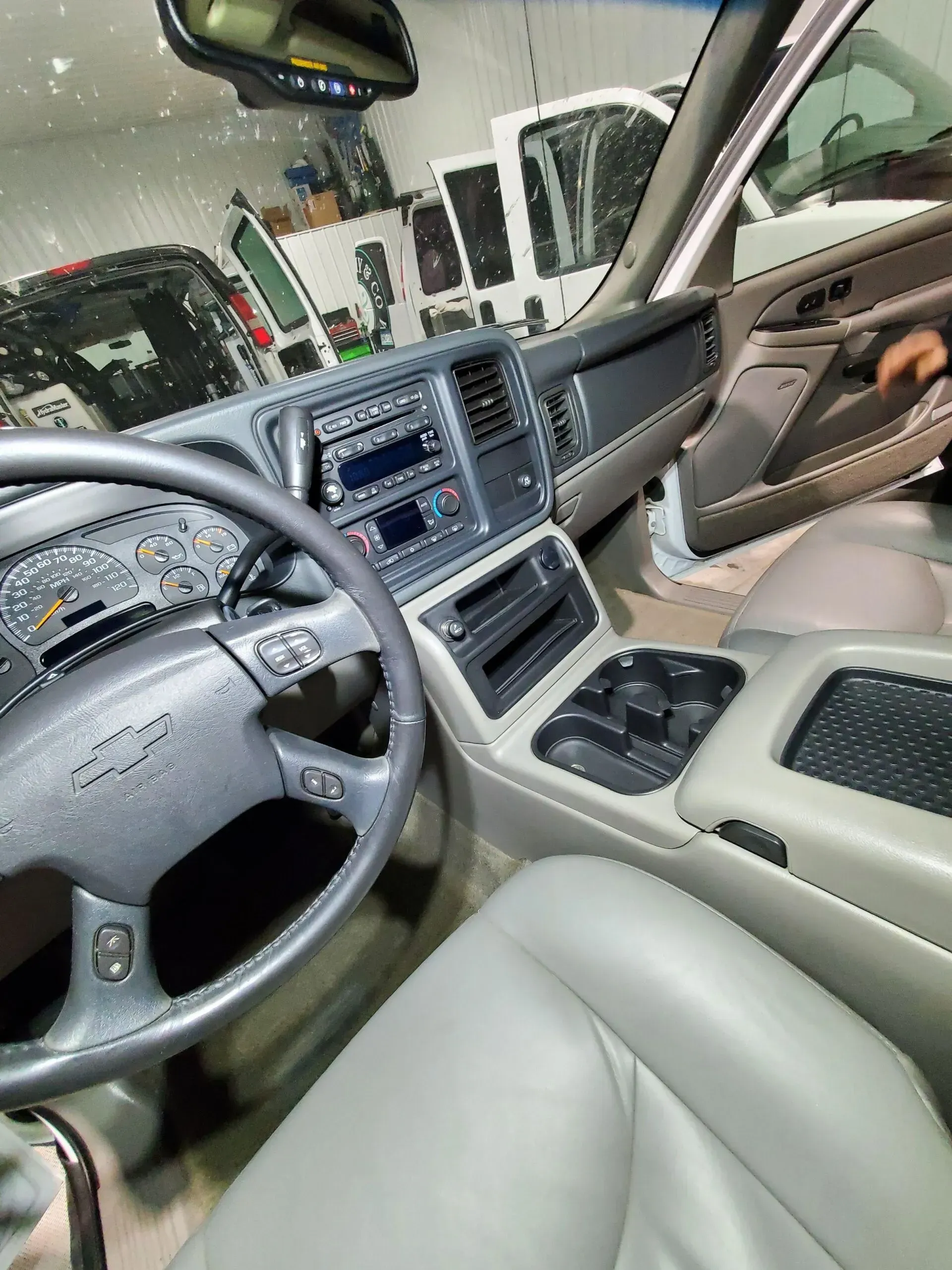 The inside of a car with a steering wheel and a dashboard.
