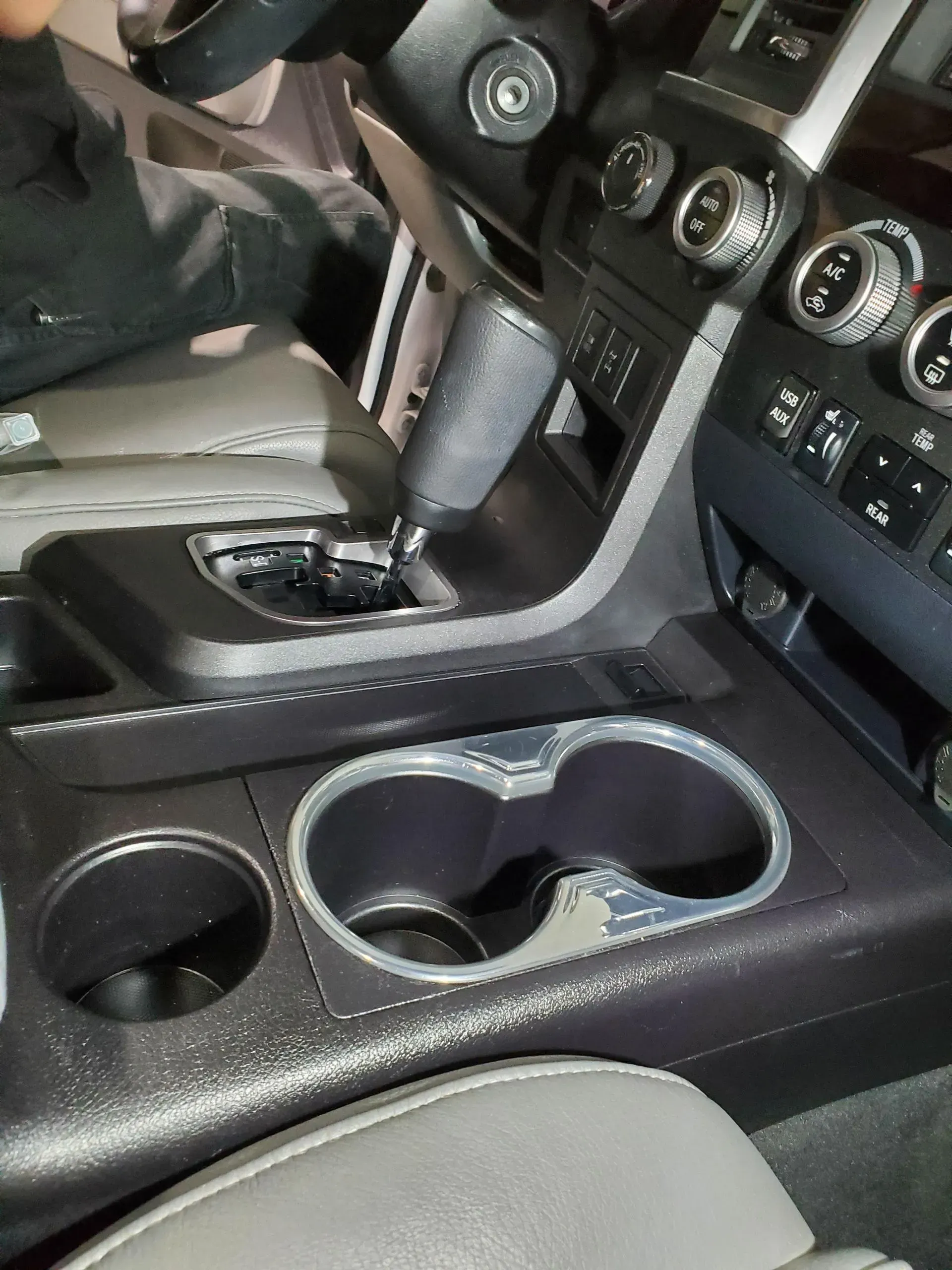 A person is sitting in the driver 's seat of a car.