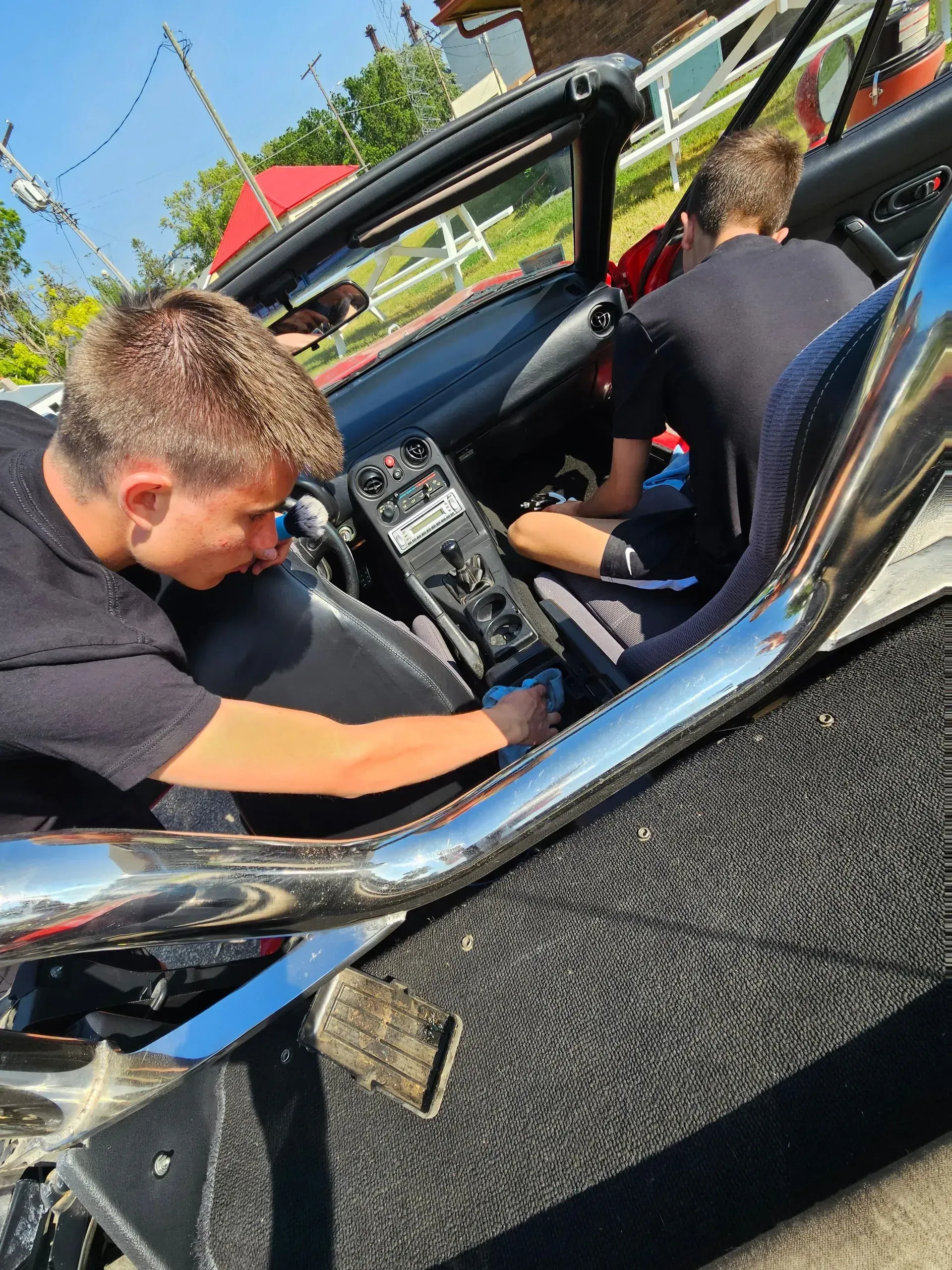 A man is working on the interior of a car.