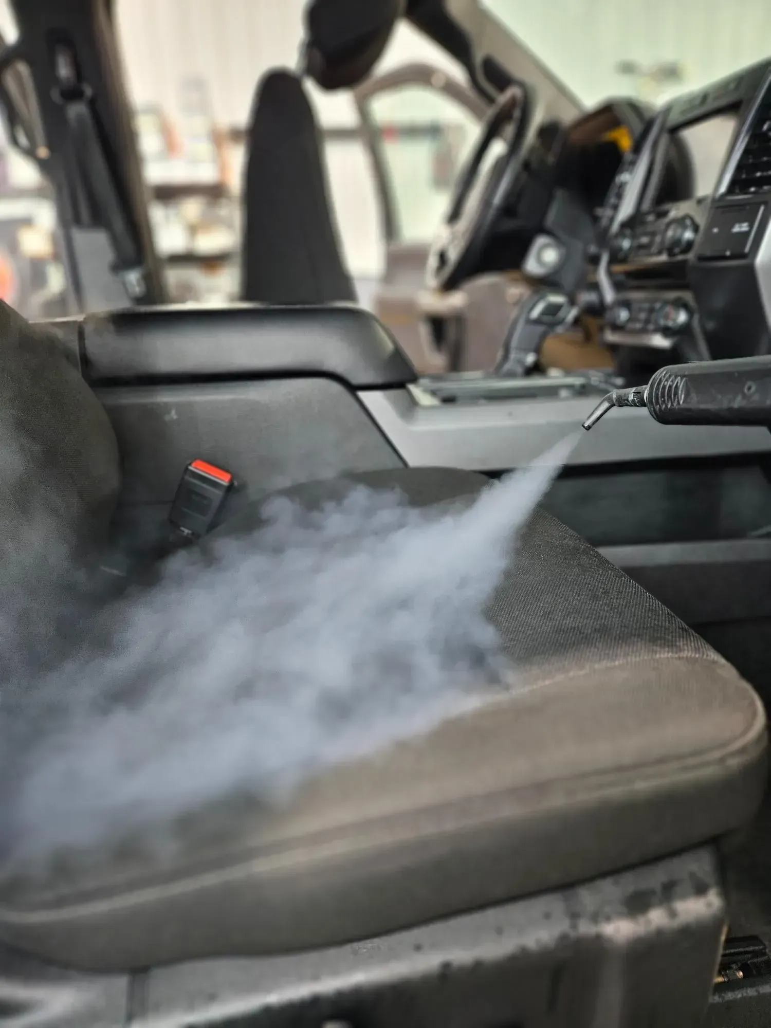 A close up of a car seat with smoke coming out of it.