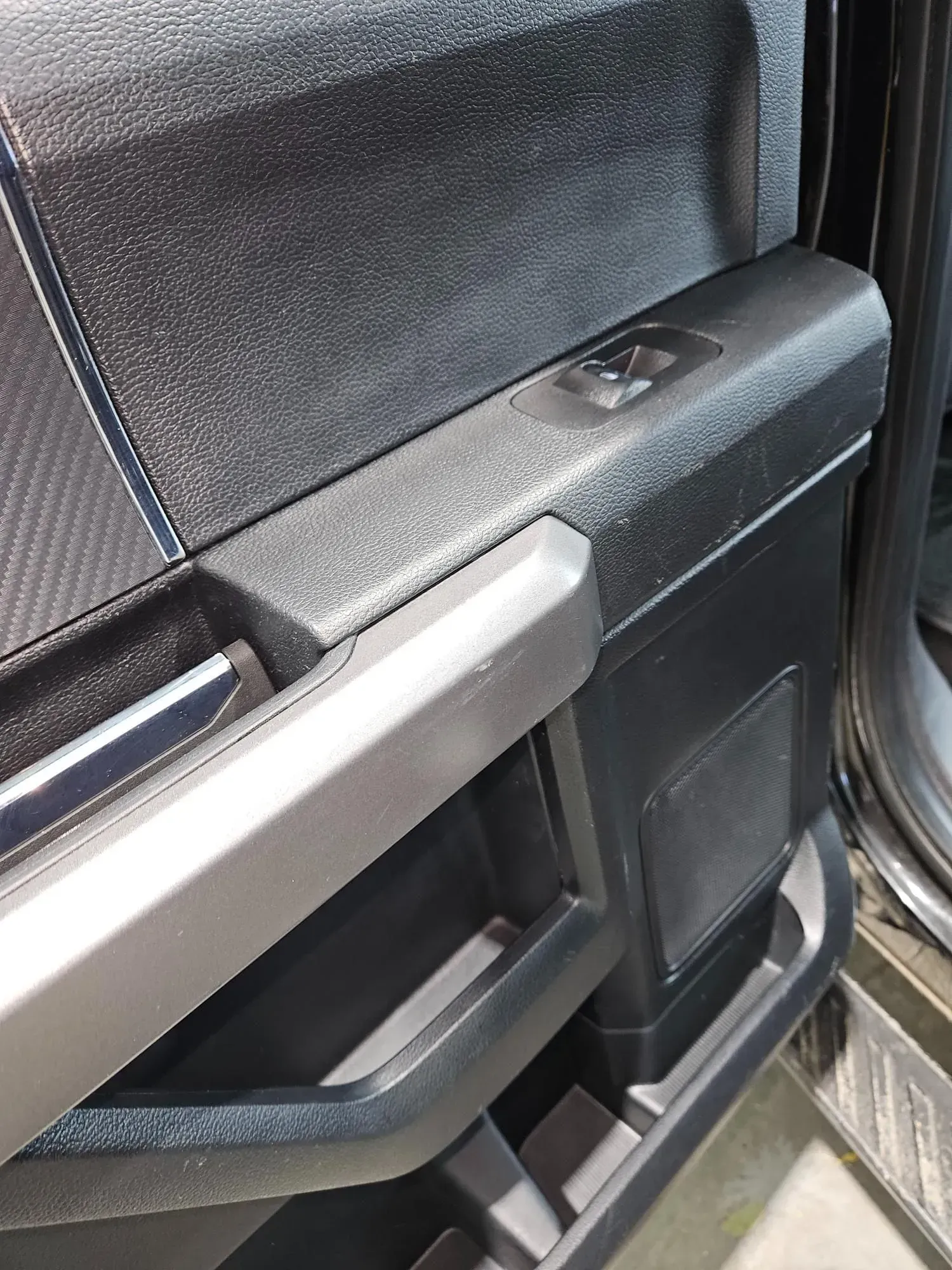 A close up of a door handle on a car.