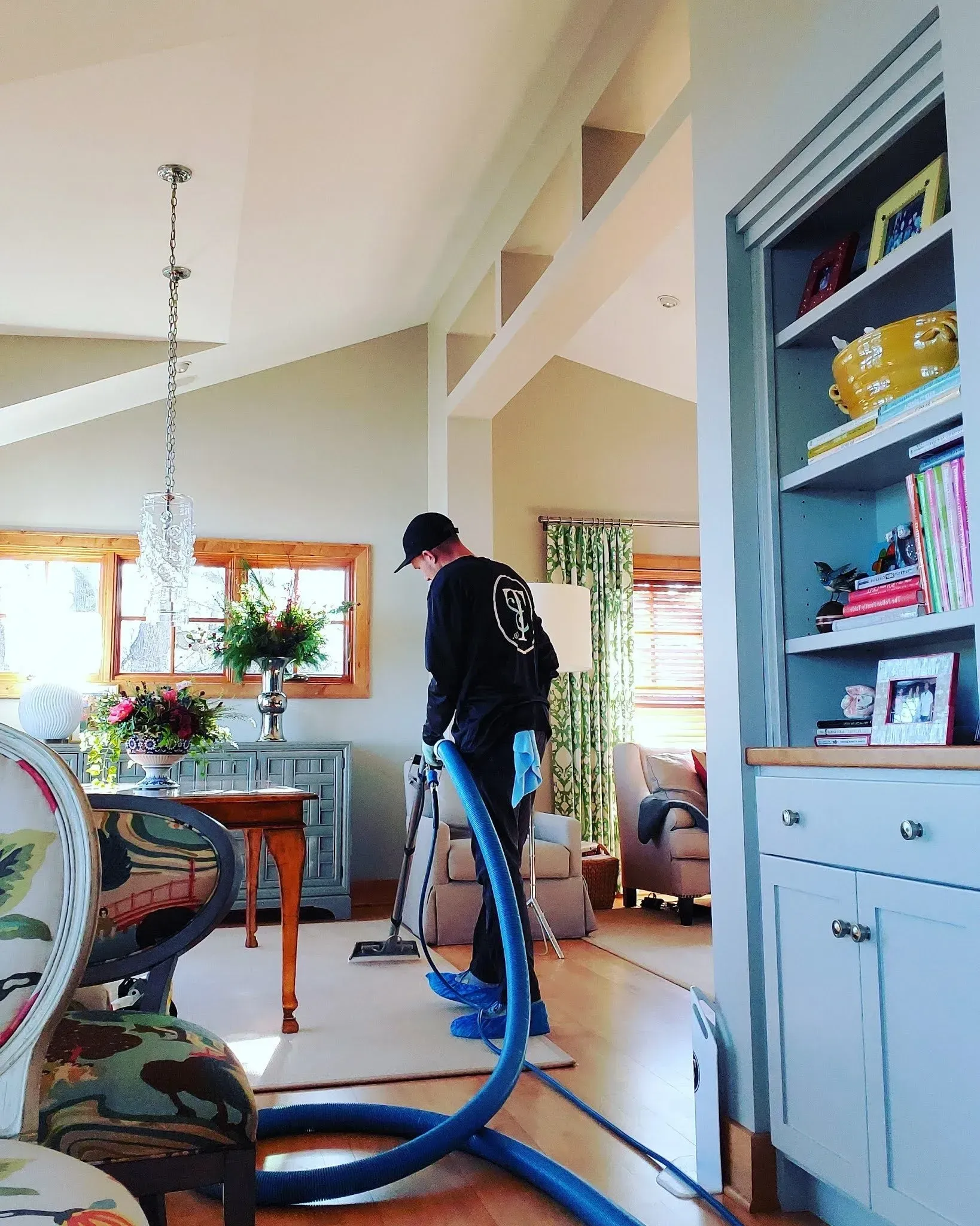 A man is using a vacuum cleaner in a living room.