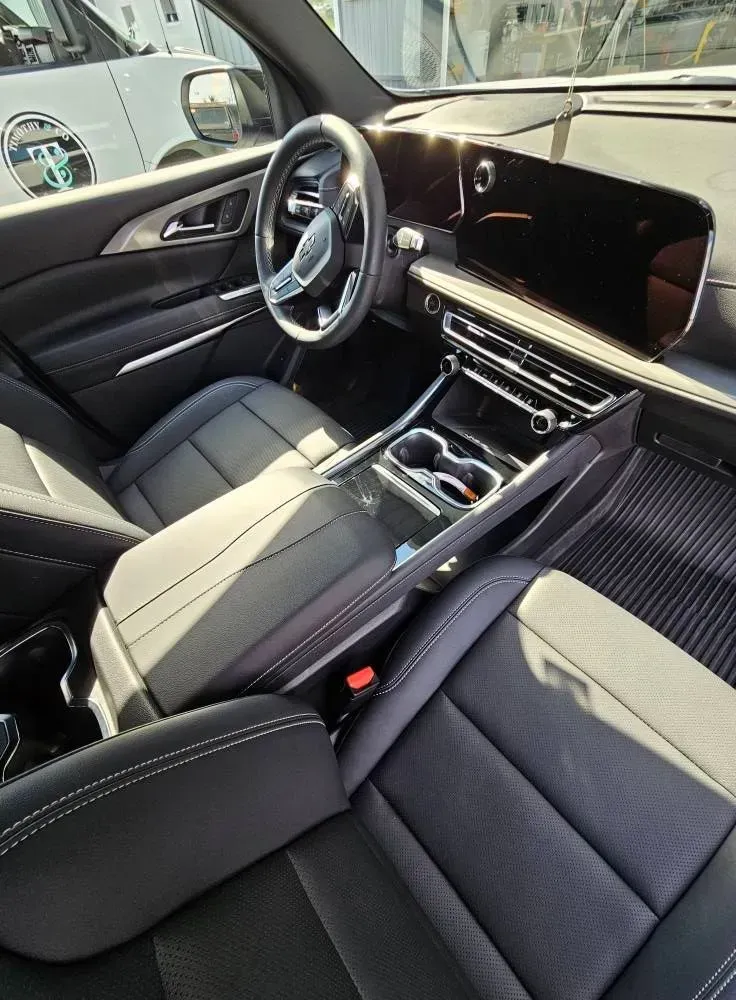 The interior of a car with a steering wheel and a dashboard.