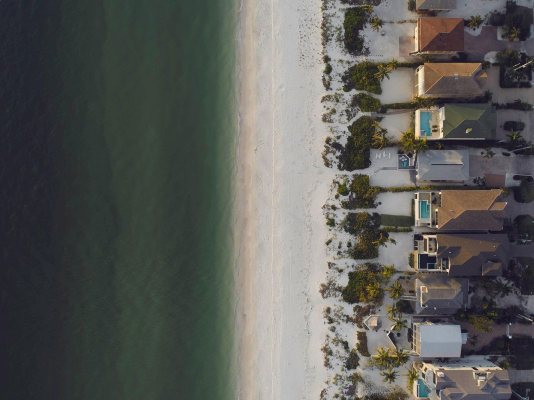 line of homes on the beach. Contact Daytona Beach roof pros