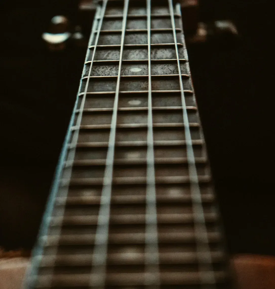A close up of the neck of an acoustic guitar.