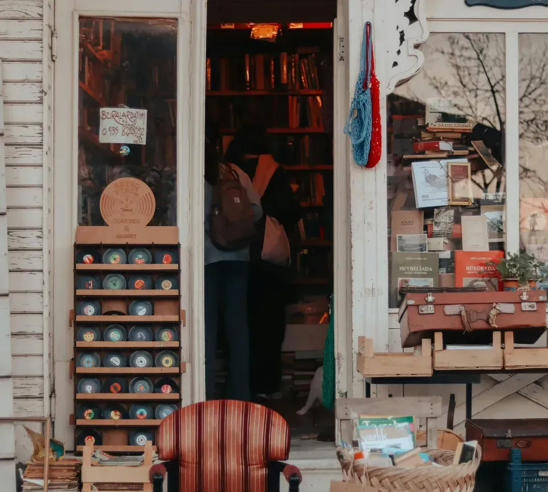 A chair is sitting outside of a bookstore.