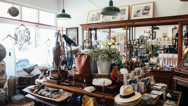 A store filled with lots of clothes , hats , and other items.