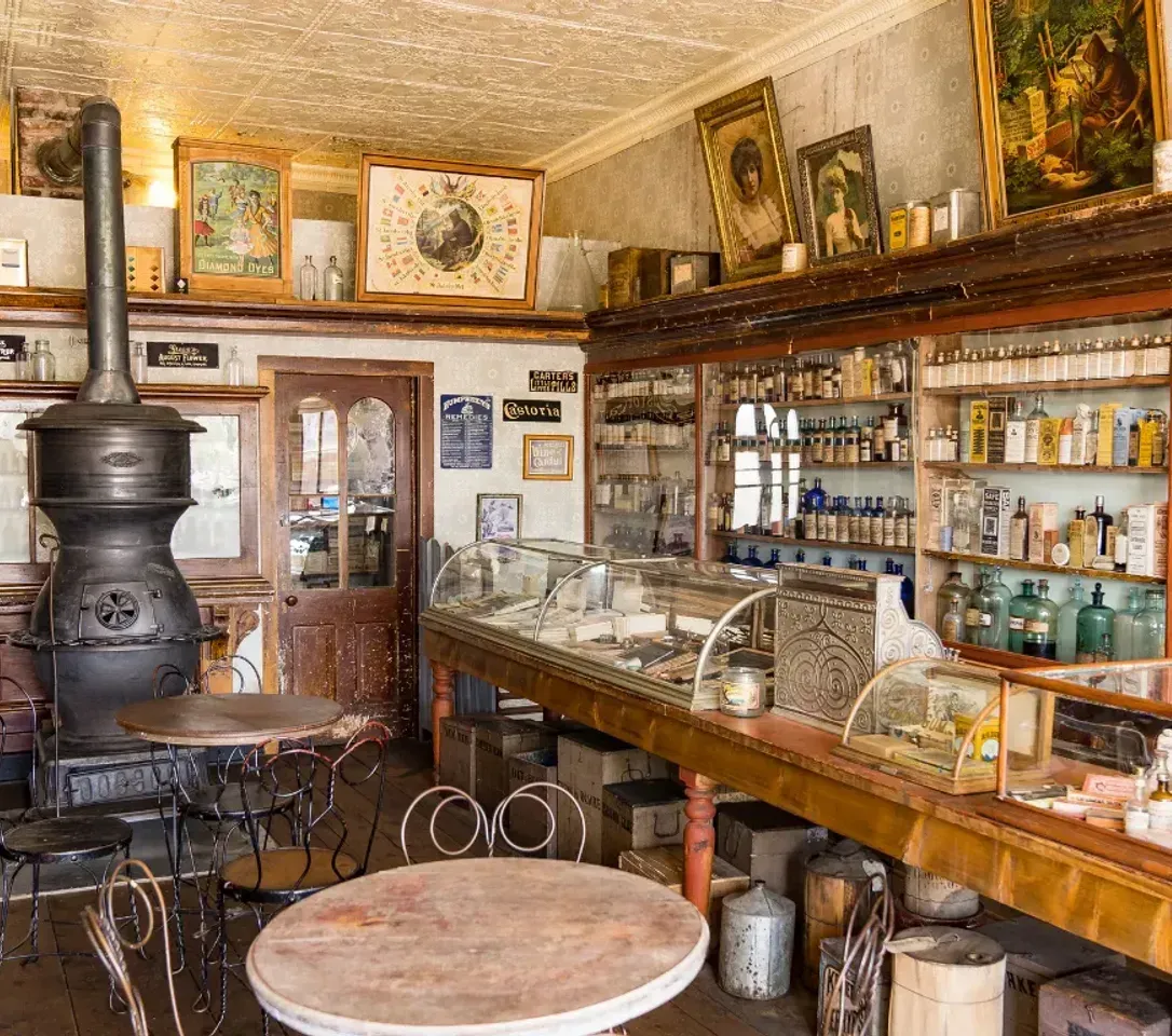 There is a table in the middle of the room in an old store.