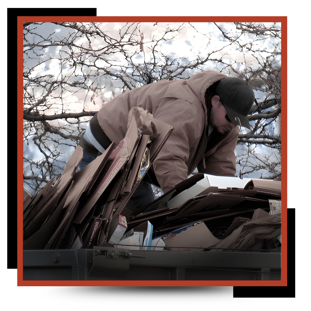 a garbage man piling the junk