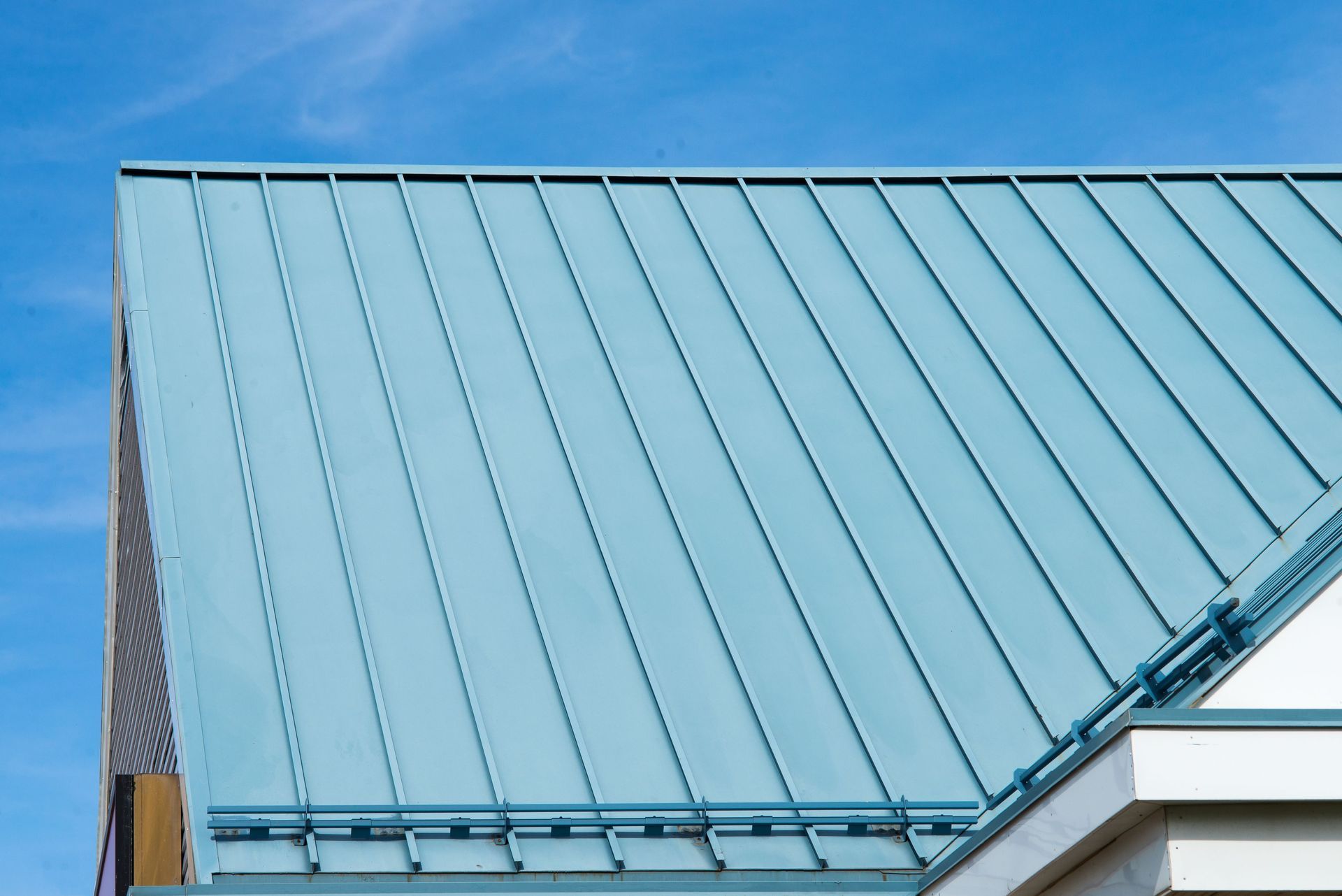 A Close Up of a Blue Metal Roof With a Blue Sky in the Background — Apex Roofing Group in Lennox Head, NSW