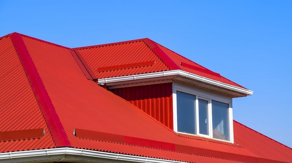 A Red Roof with A Window on Top of It — Apex Roofing Group in Kingscliff, NSW