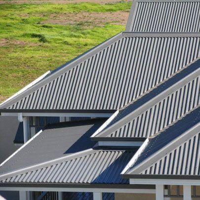 Multiple pitched roofs featuring traditional corrugated metal sheets in a grey finish, providing a modern, durable look with good water runoff. — Apex Roofing Group in Coolangatta, QLD