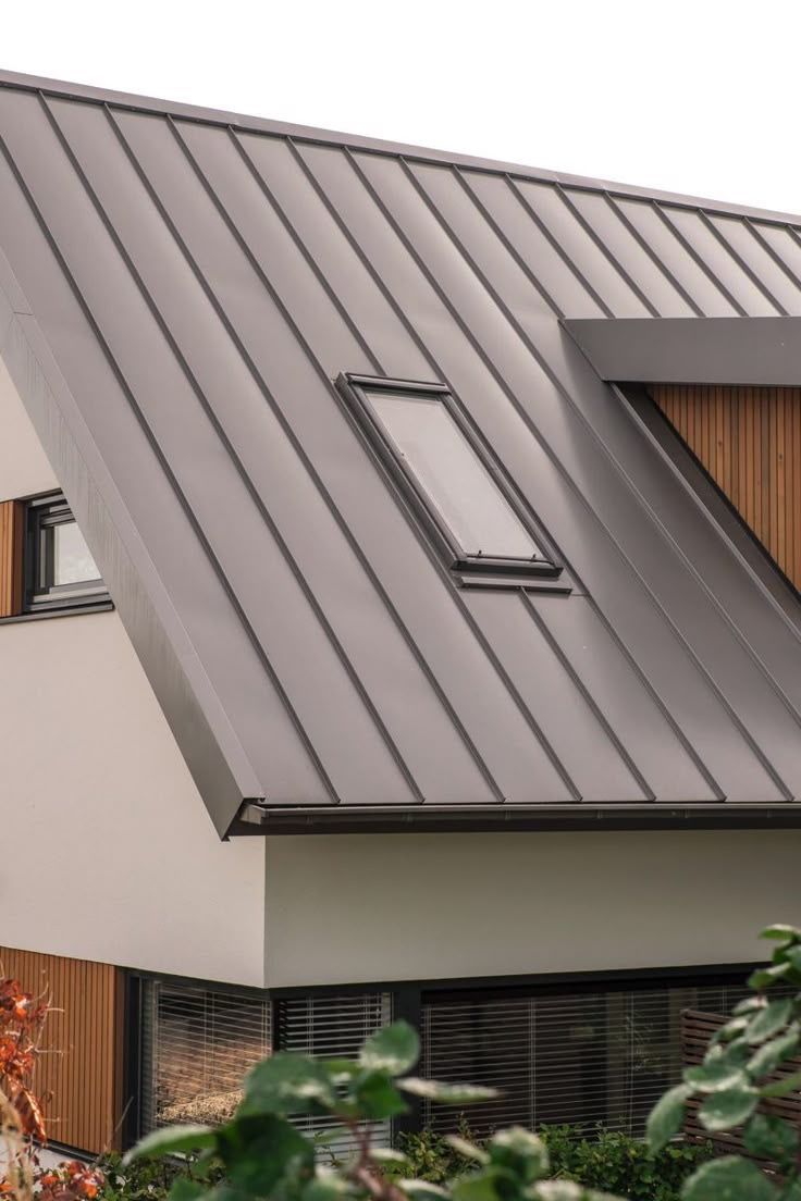 Close-up of a modern standing seam metal roof in matte grey with a skylight, on a minimalist home exterior. — Apex Roofing Group in Byron Bay, NSW