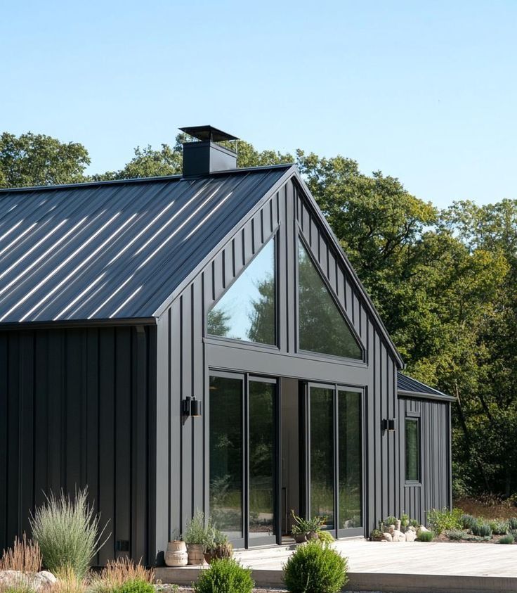 A Black House with A Triangle Shaped Roof — Apex Roofing Group in Lismore, NSW