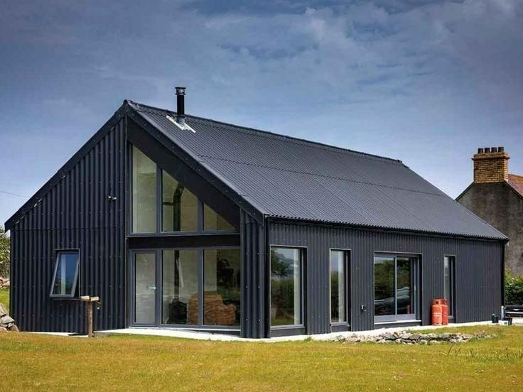 A Black House with A Slanted Roof — Apex Roofing Group in Woolgoolga, NSW
