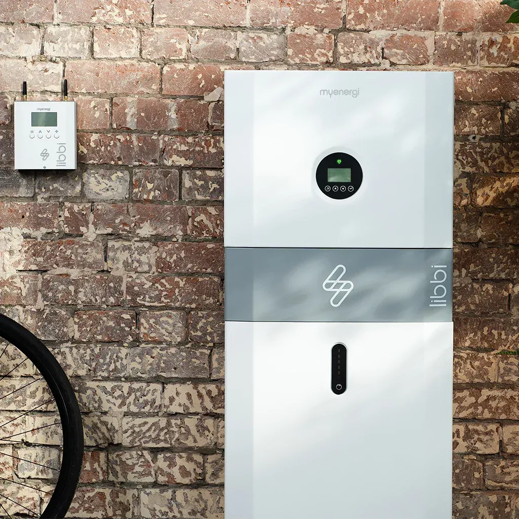 A brick wall with a myenergi libbi battery storage system on it