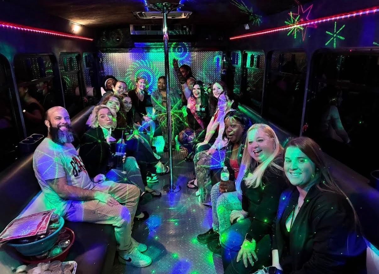 a black limousine is parked next to a red carpet .