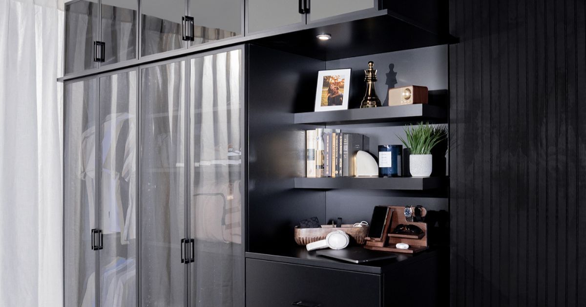 Modern bathroom with black shelving, toiletries, a sink, and a frosted glass shower curtain
