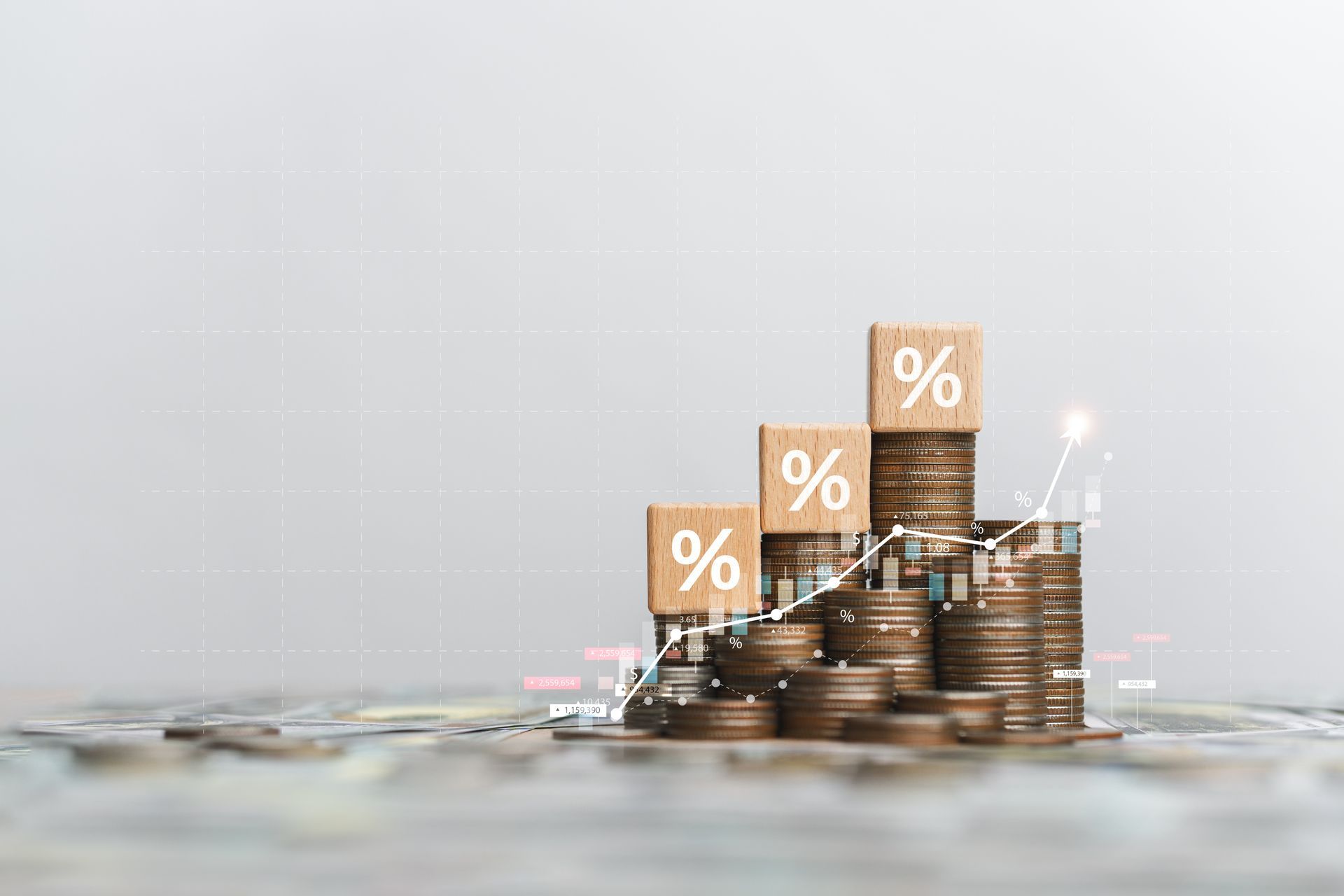 Stacks of coins with wooden blocks marked with percentages, representing financial growth.