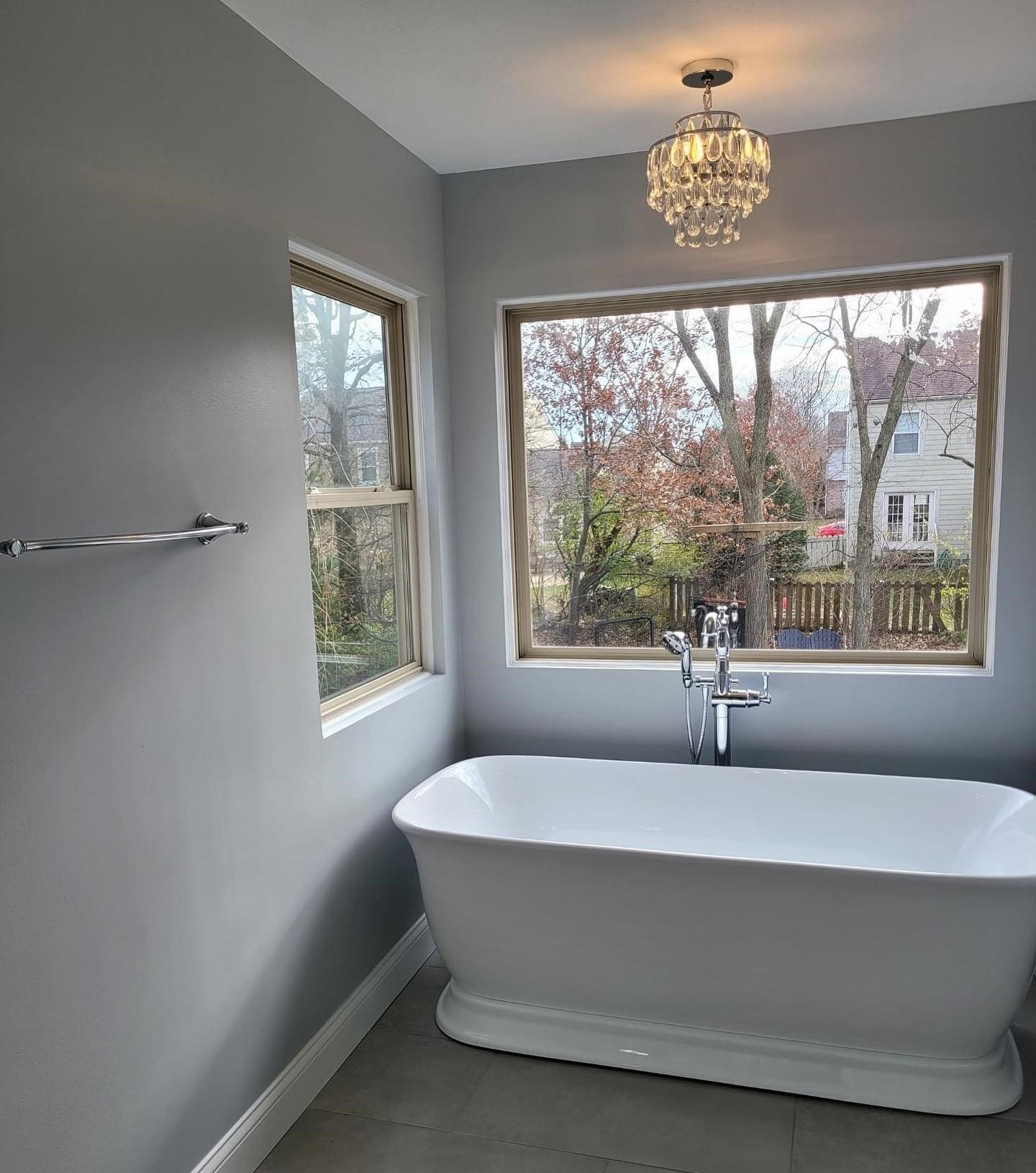 A bathroom with a bathtub and a window.