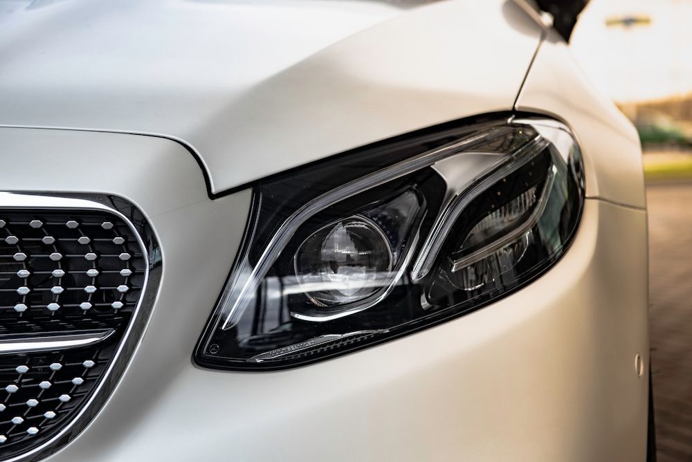 A Red Vintage Car is Parked in Front of a Building — Adettra in Tuncurry, NSW