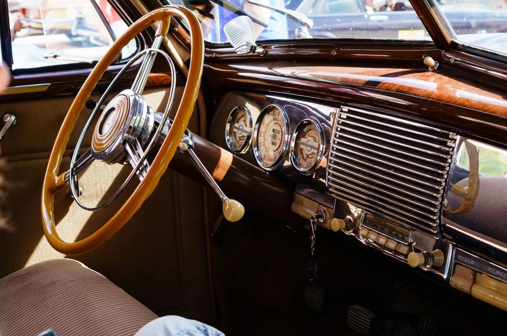 The Inside of an Old Car With a Wooden Steering Wheel — Adettra in Tuncurry, NSW