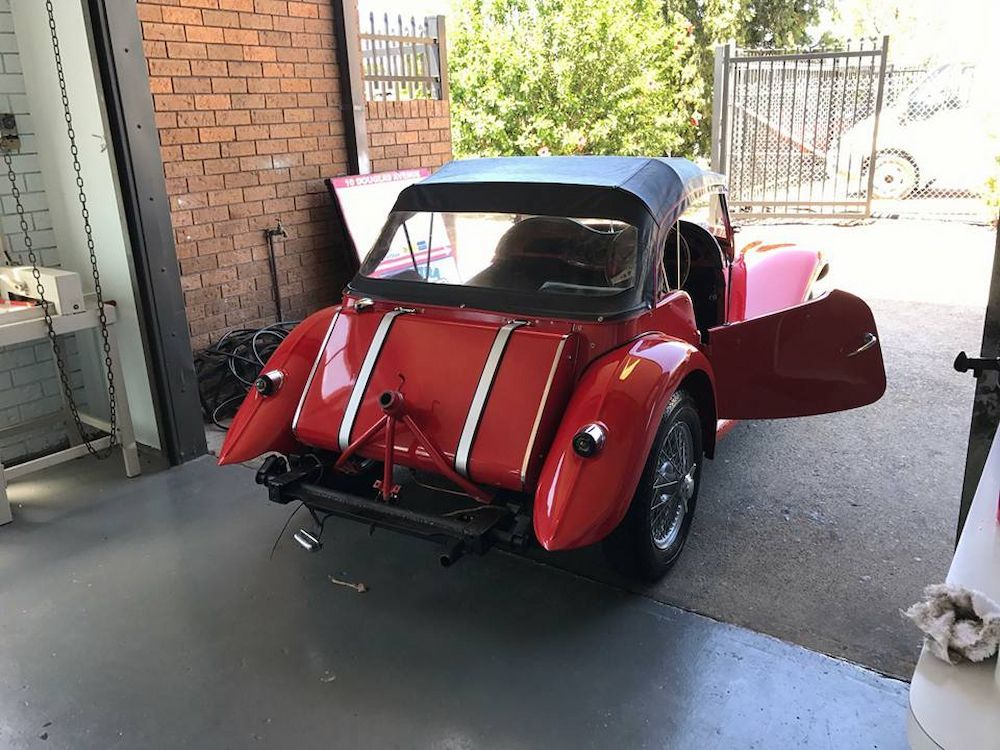 A Red Car is Parked in a Garage With Its Doors Open — Adettra in Tuncurry, NSW