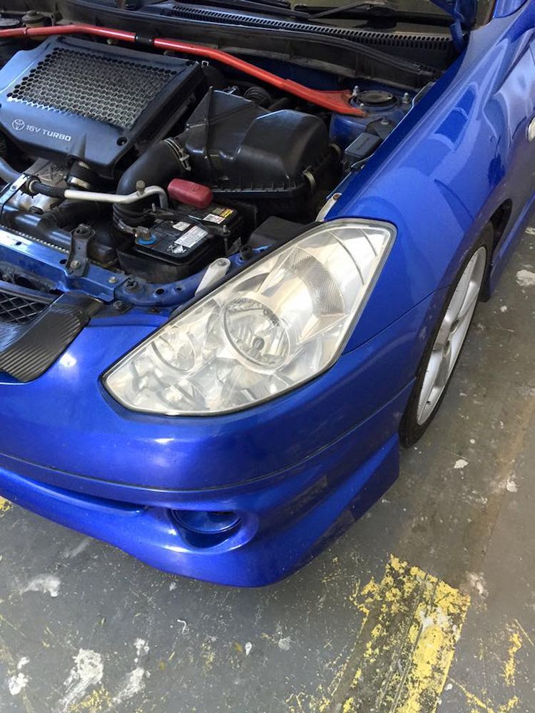A Blue Car With the Hood Up is Parked in a Garage — Adettra in Tuncurry, NSW