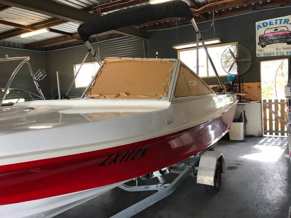 A Red and White Boat is Parked in a Garage — Adettra in Tuncurry, NSW