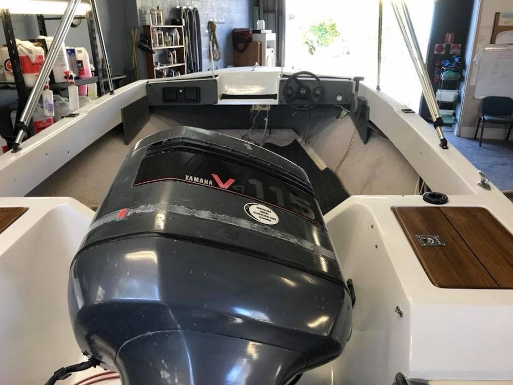 A Boat With a Yamaha Outboard Motor is Sitting in a Garage — Adettra in Tuncurry, NSW