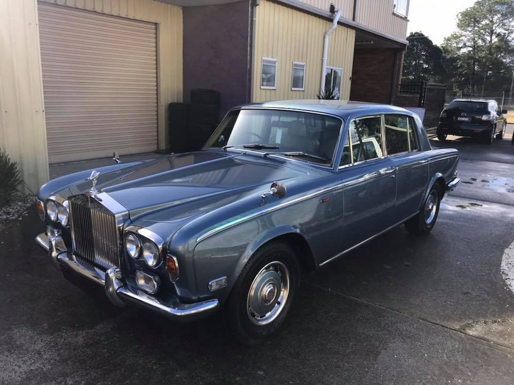 A Blue Rolls Royce is Parked in Front of a Building — Adettra in Tuncurry, NSW