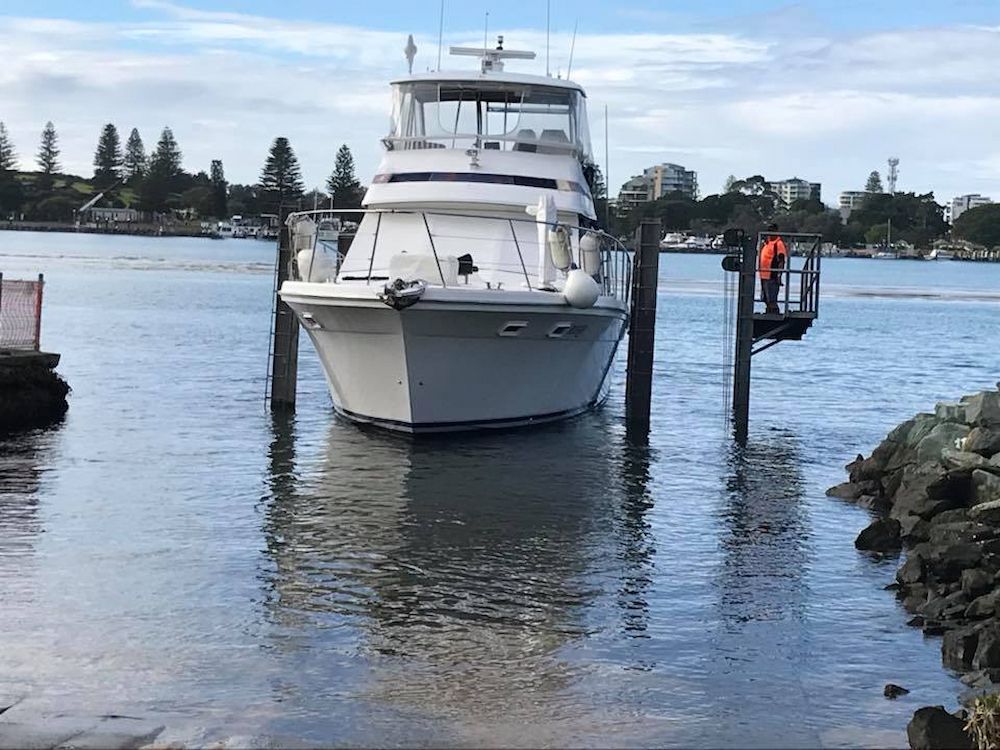 A Large White Boat is Docked at a Dock in the Water — Adettra in Tuncurry, NSW