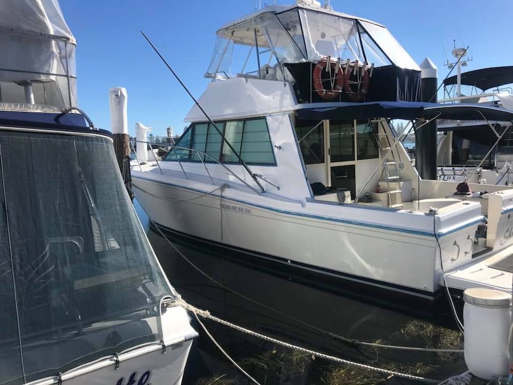 A Couple of Boats Are Docked Next to Each Other in a Marina — Adettra in Tuncurry, NSW