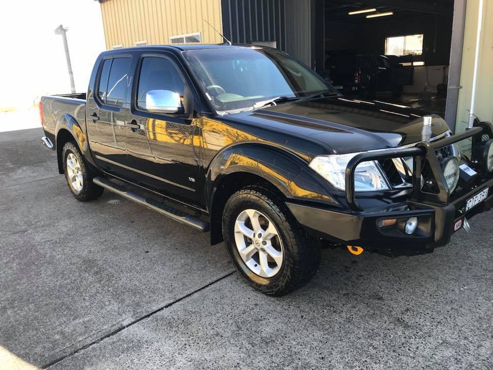 A Black Pickup Truck is Parked in Front of a Building — Adettra in Tuncurry, NSW