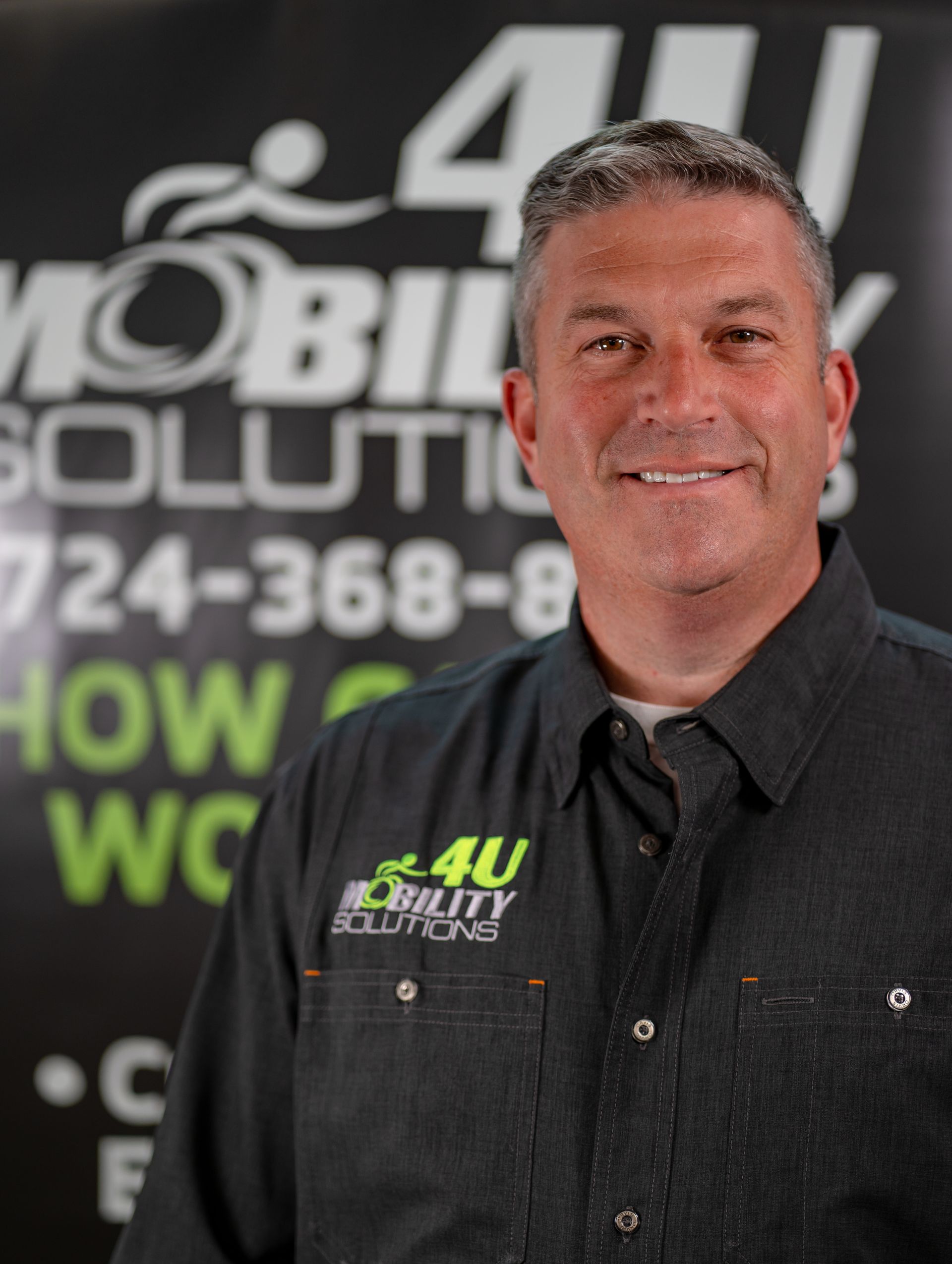 A man wearing a shirt that says 4u mobility solutions