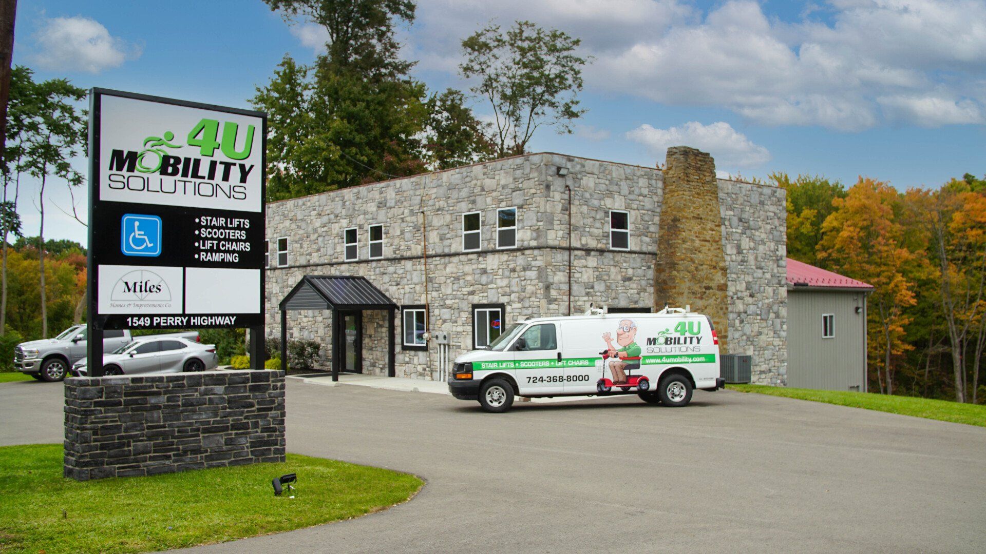 An ambulance is parked in front of a building with a sign that says mobility solutions