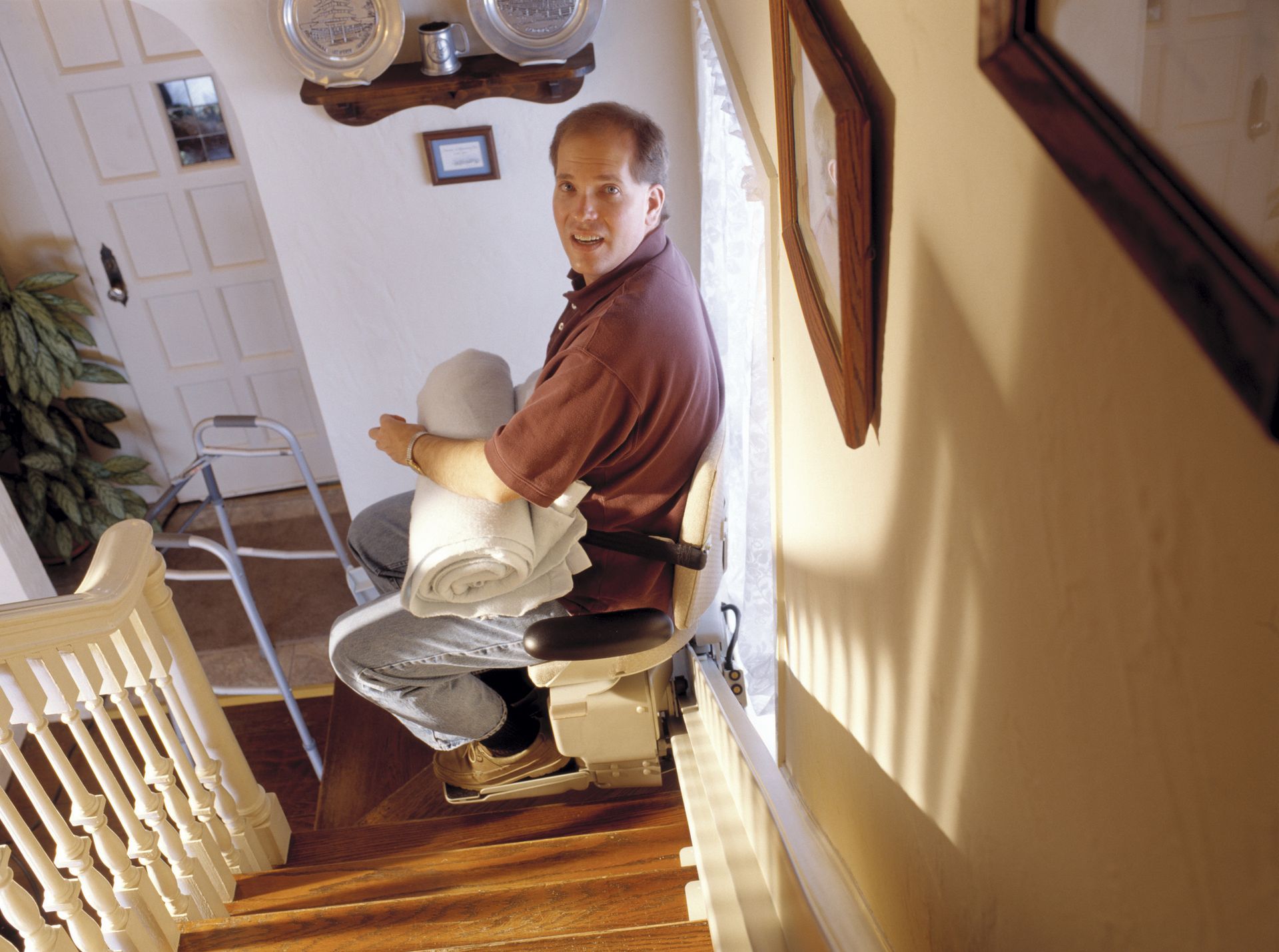 Man in stair lift doing chores. Man in stair lift doing chores.