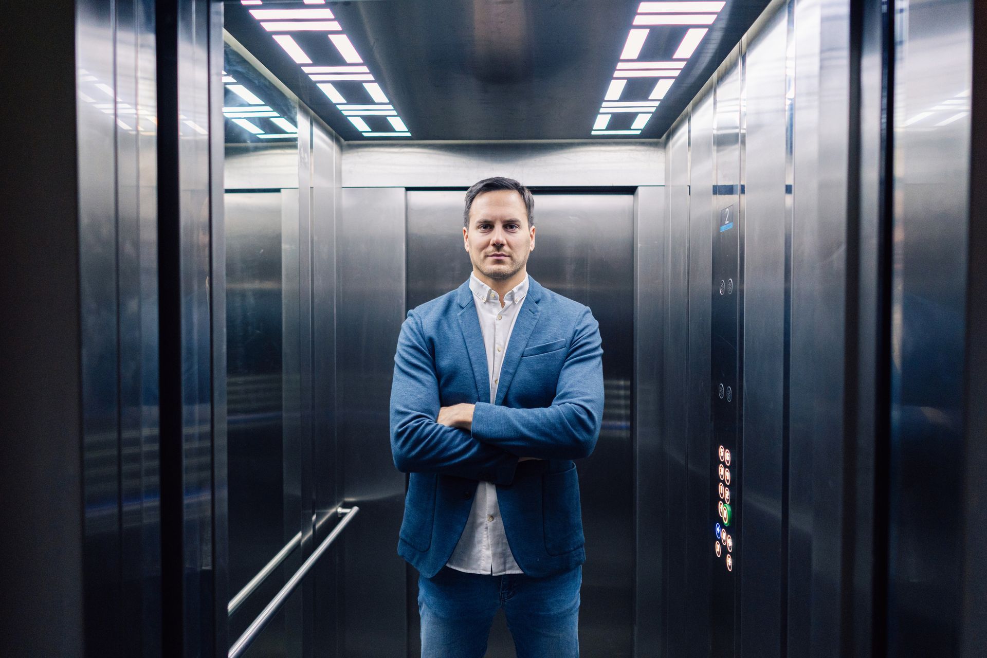 Young man in the residential elevator. Young man in the residential elevator.