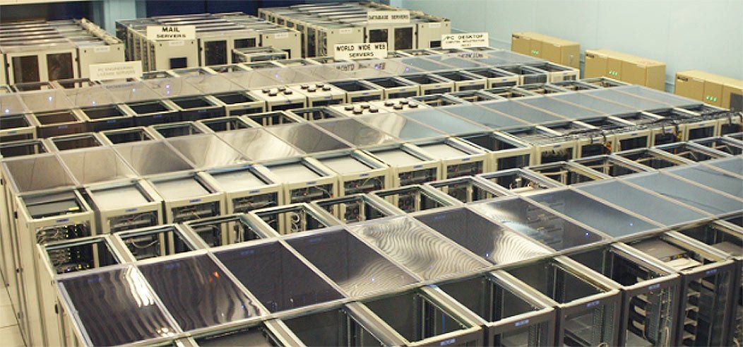 Rows of computer hardware in a large facility.
