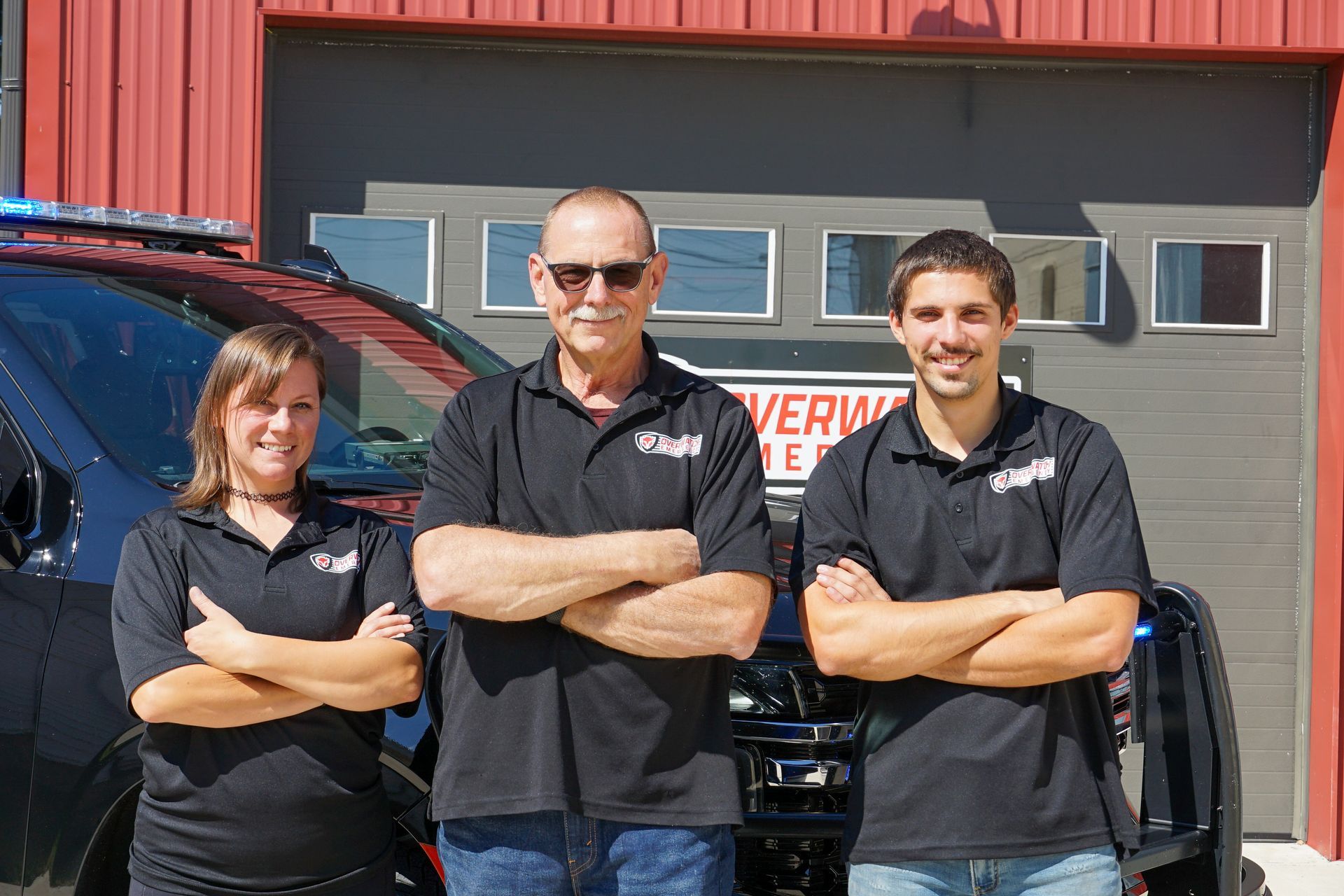 A group of paramedics are standing in front of an ambulance.