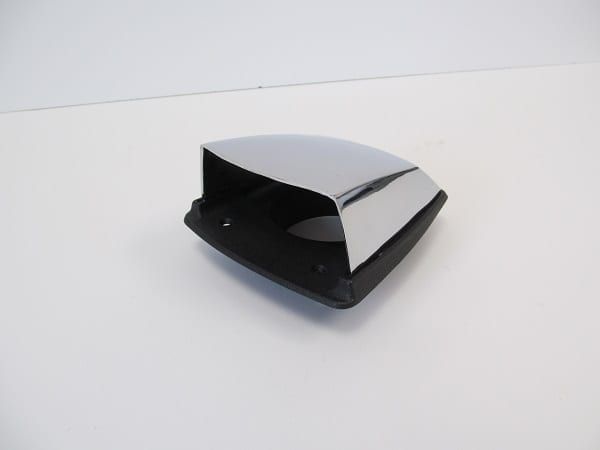 A black and chrome object is sitting on a white surface