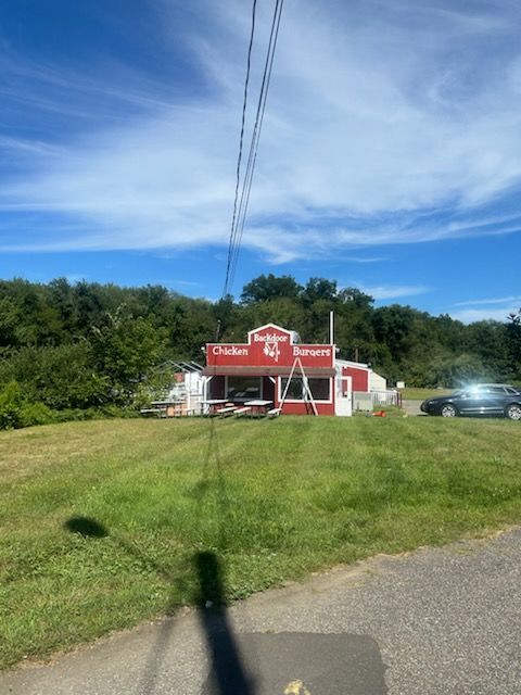 Red and white roadside diner with sign