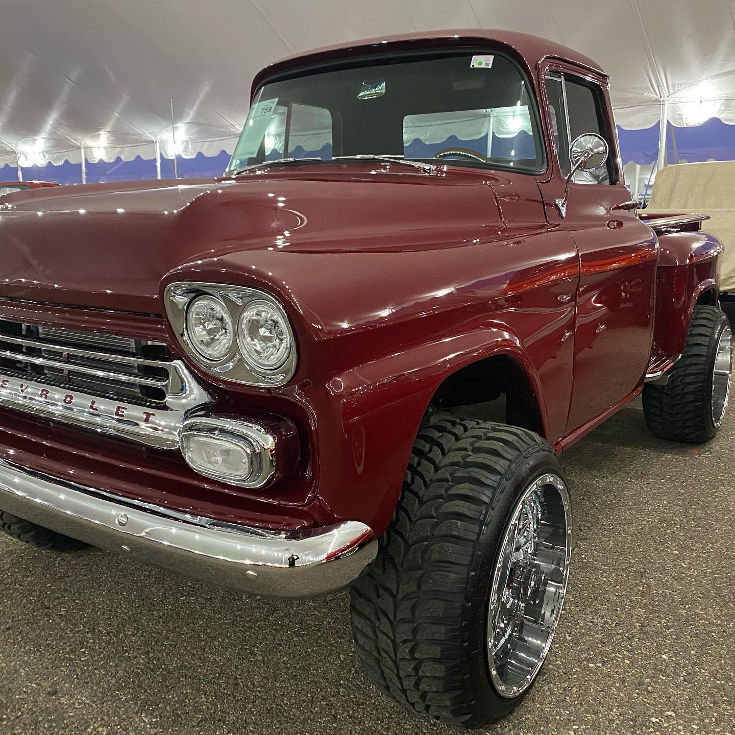 a red truck parked in a tent .