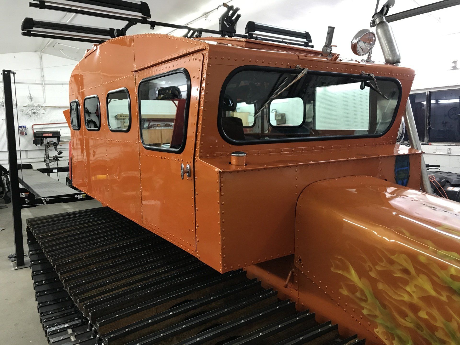a large orange vehicle parked in a garage