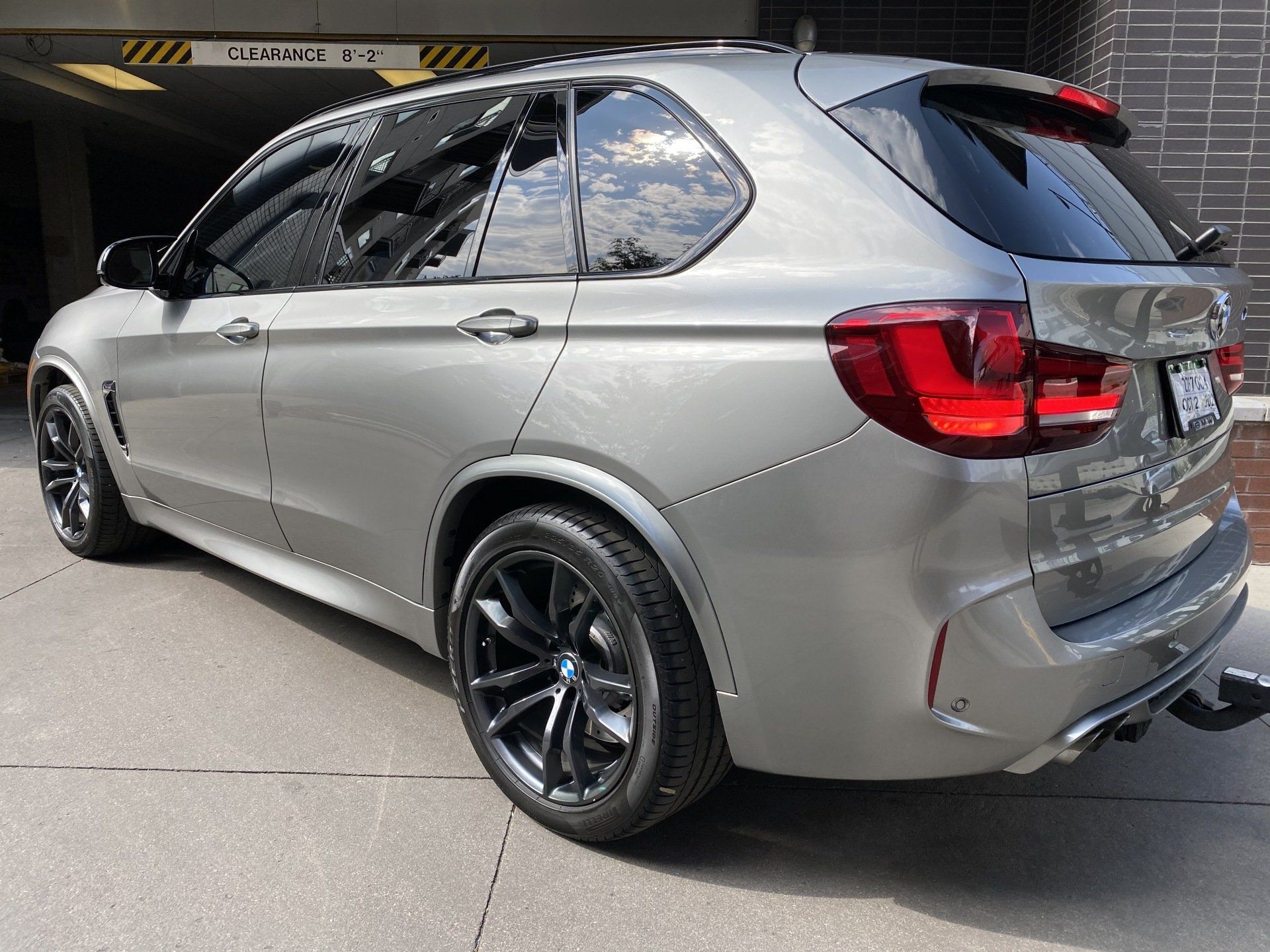a silver car is parked in front of a brick building .