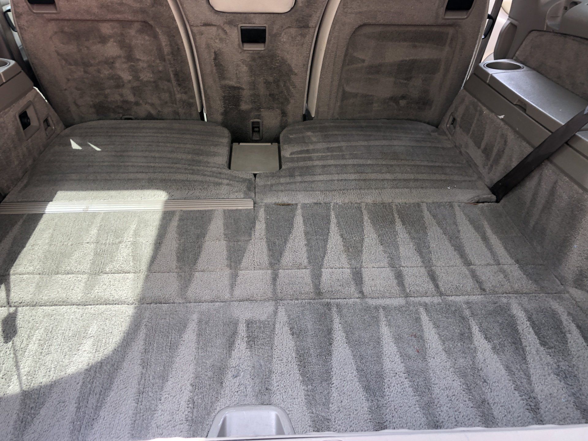 the trunk of a car with a carpeted floor
