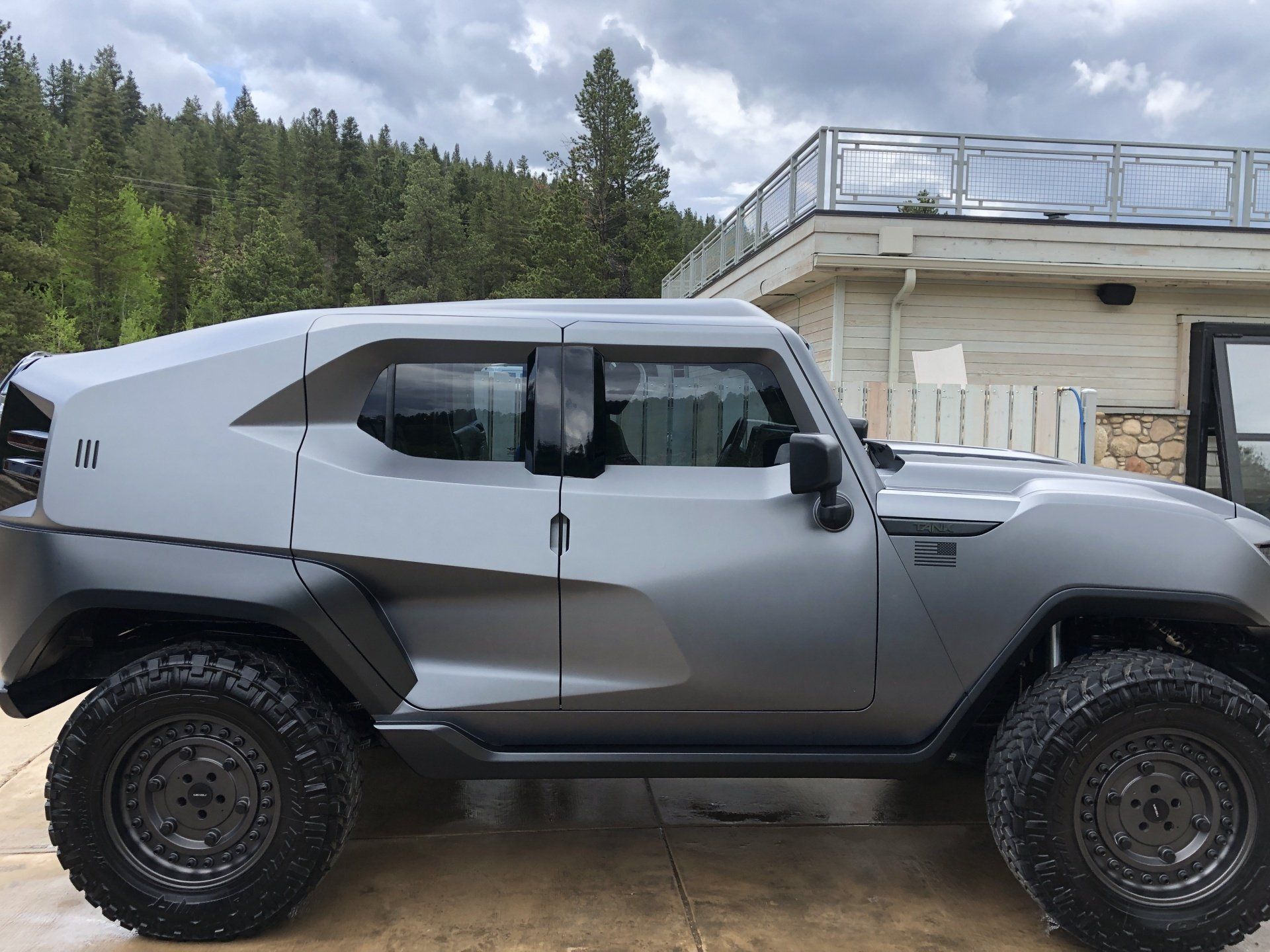a gray jeep parked in front of a house