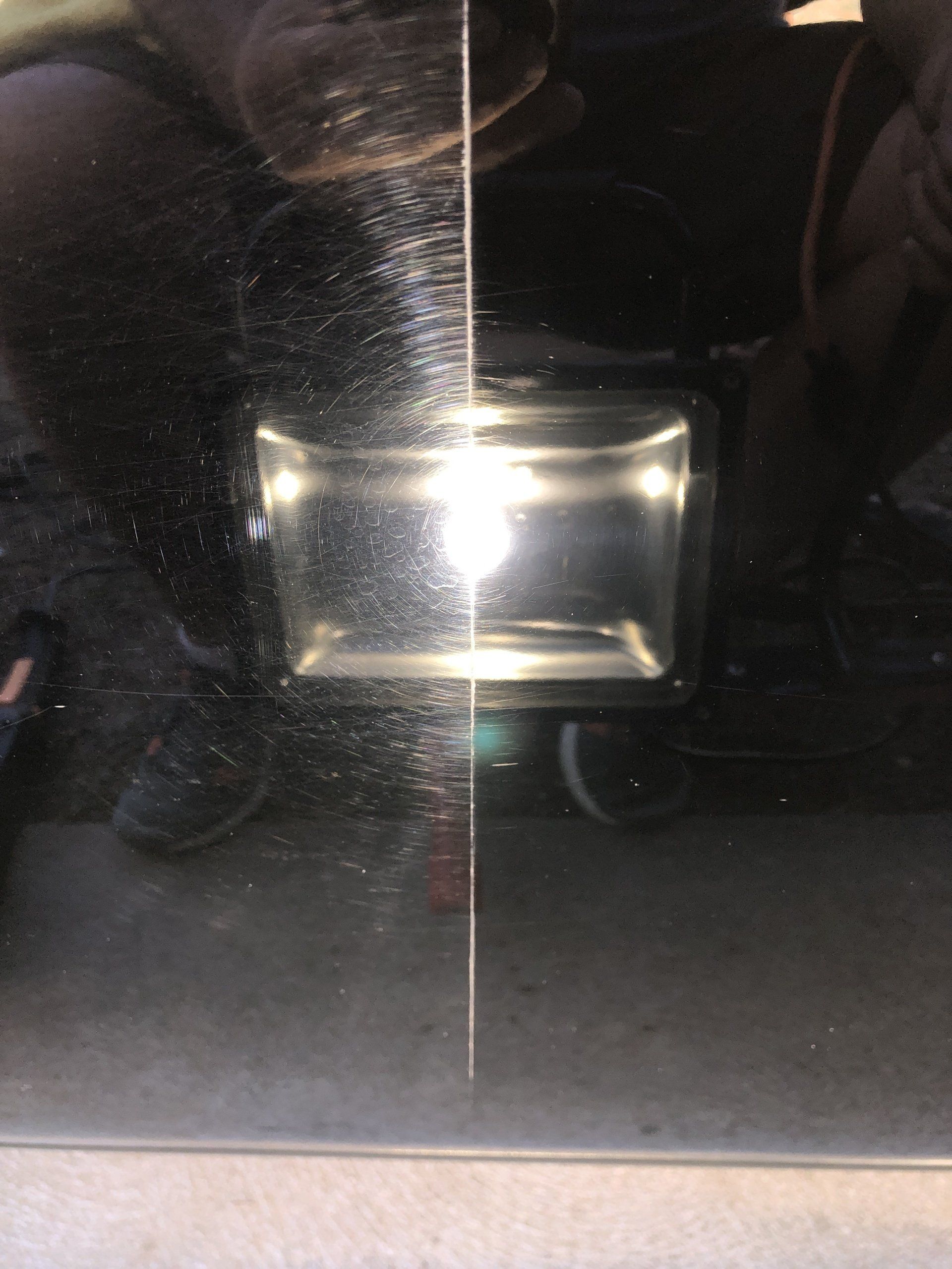 a reflection of a light on a black surface